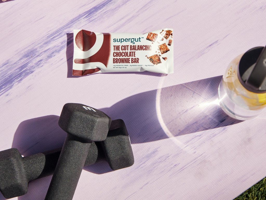 An image of supergut bars near weights and a bottle